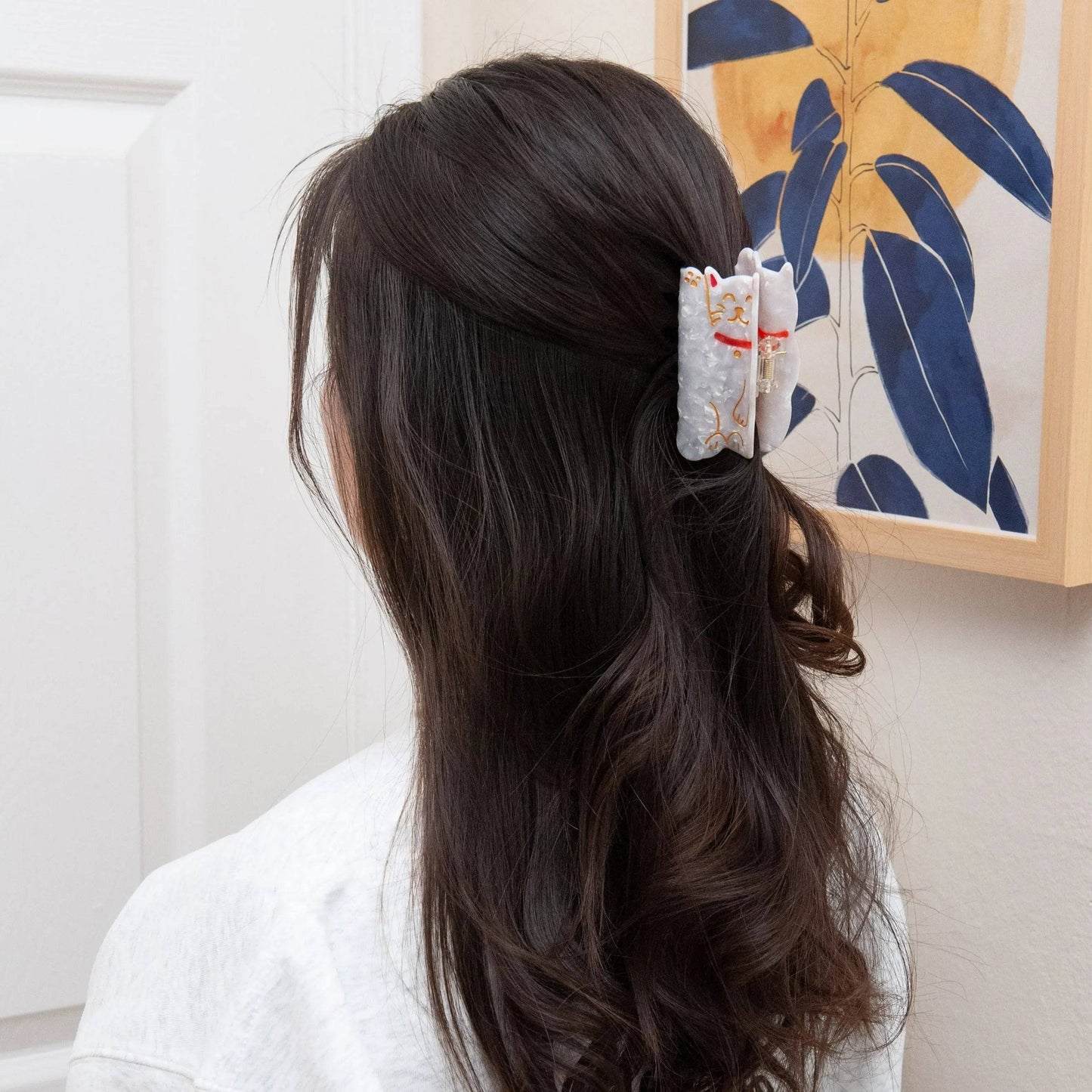a woman wearing our Japanese style luck cat hair clip for half up half down hairstyle