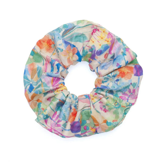 Watercolor fabric scrunchie featuring a vibrant and artistic design, perfect for adding a pop of color to any hairstyle.