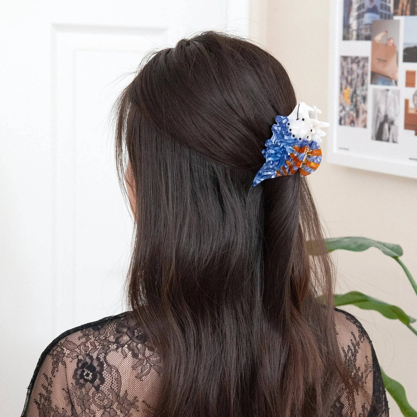 a woman wearing a cute dinosaur hair clip for half up half down hairstyle