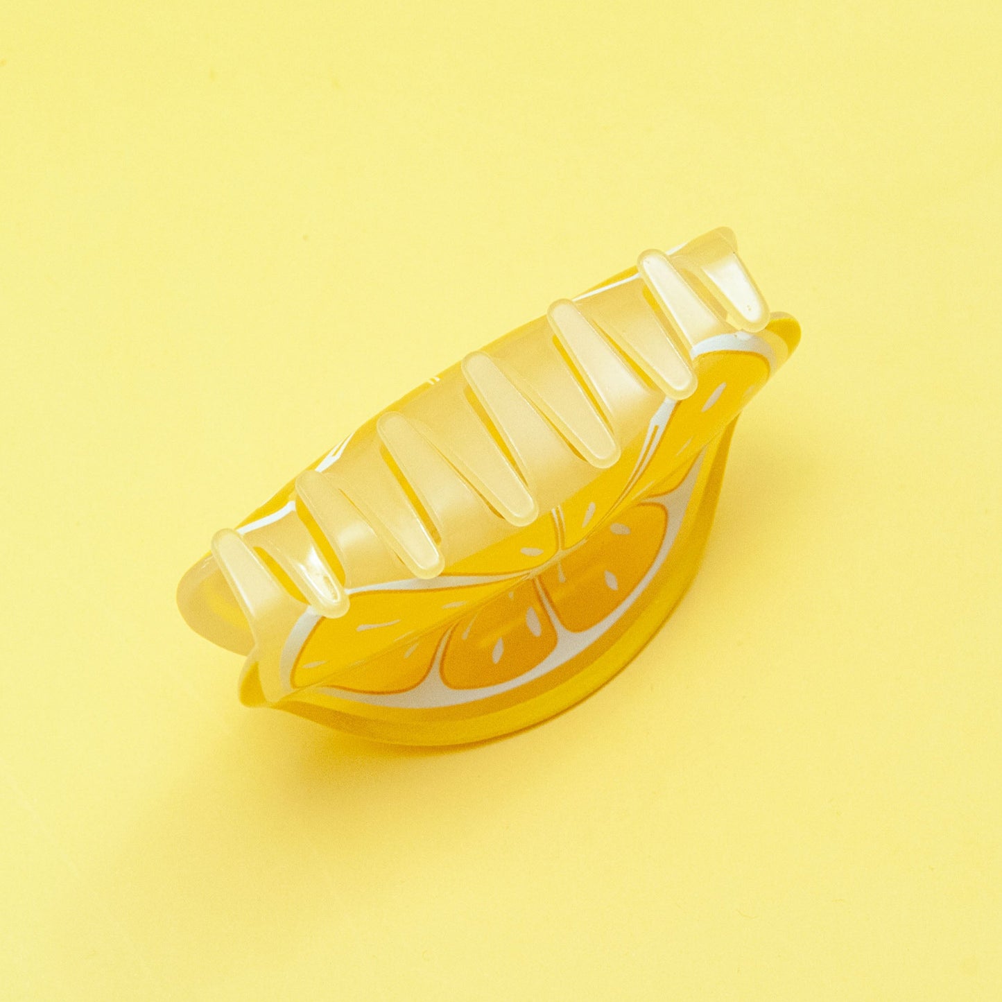 Yellow banana-shaped object on a yellow background