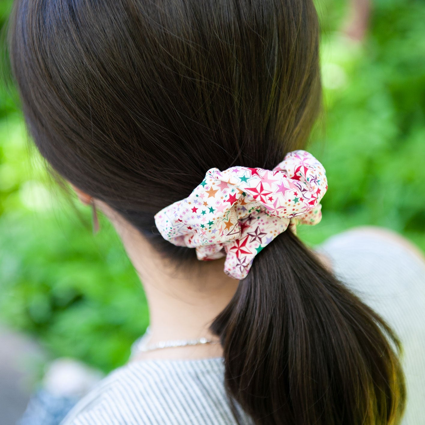 a woman wearing a liberty fabric in pink