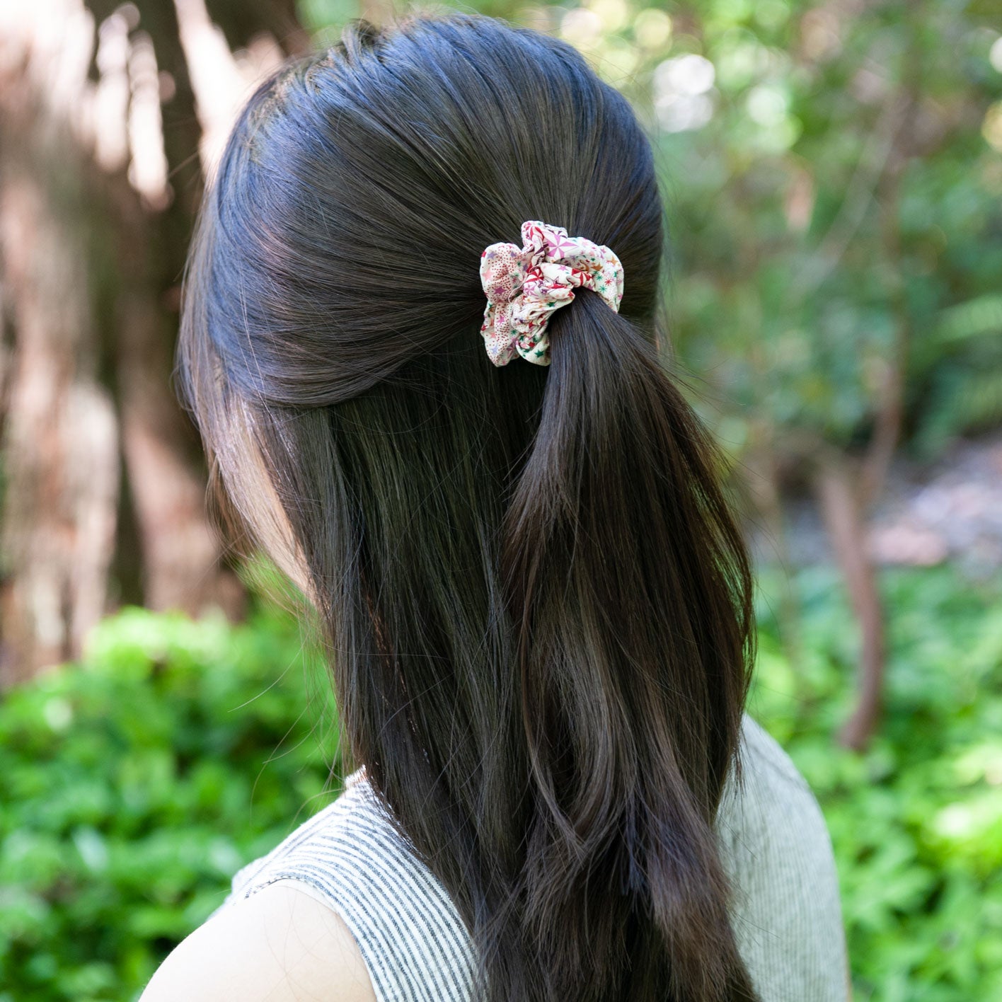 a woman wearing a skinny size liberty fabric scrunchie in pink