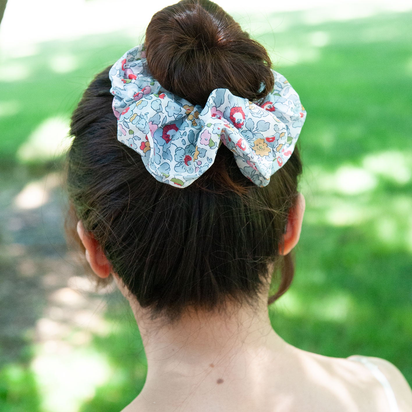 a woman wearing a liberty fabric scrunchie in large size