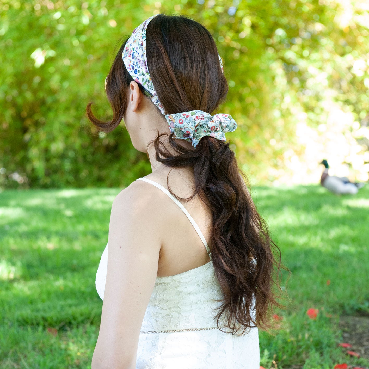 a woman wearing a liberty fabric scrunchie for ponytail