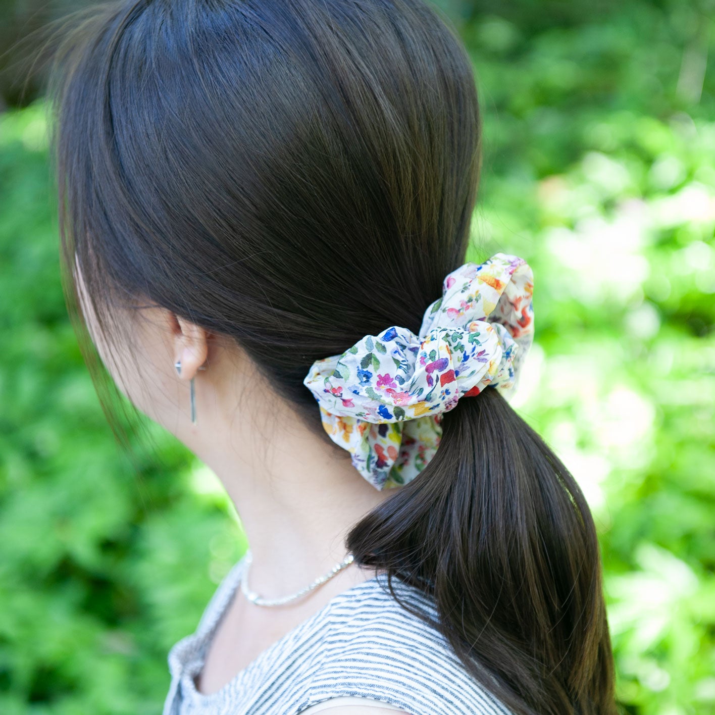 a woman wearing liberty fabric scrunchie for a ponytail