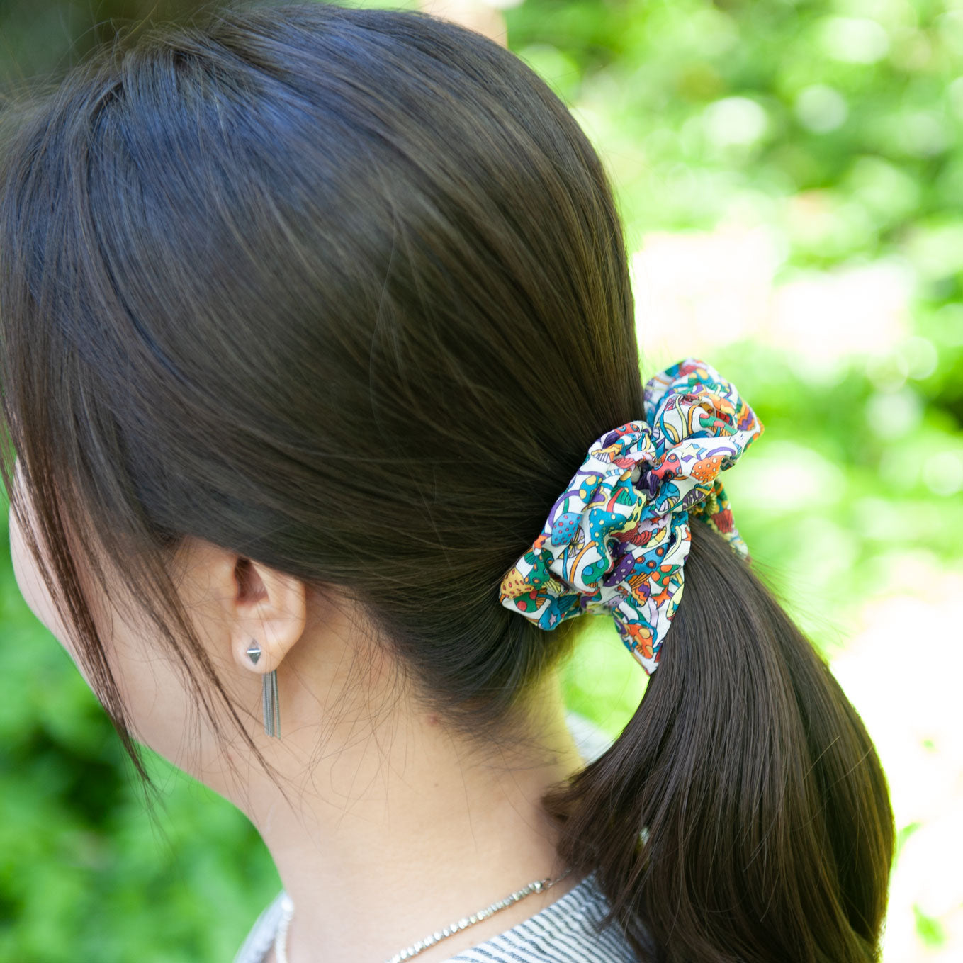a woman wearing a medium size liberty fabric scrunchie