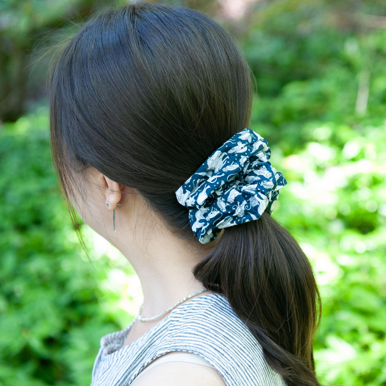 a woman wearing large scrunchie for ponytail