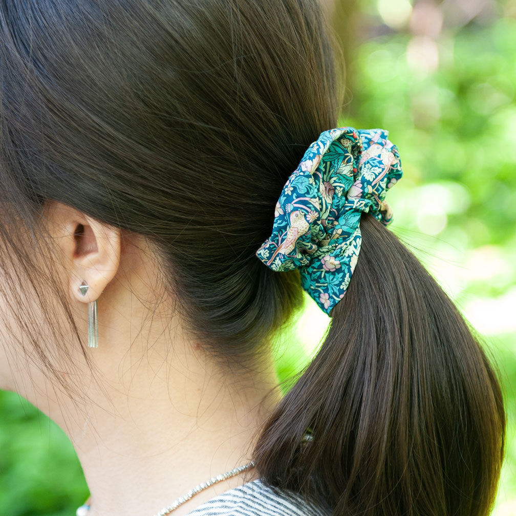 a woman wearing a liberty fabric scrunchie for ponytail