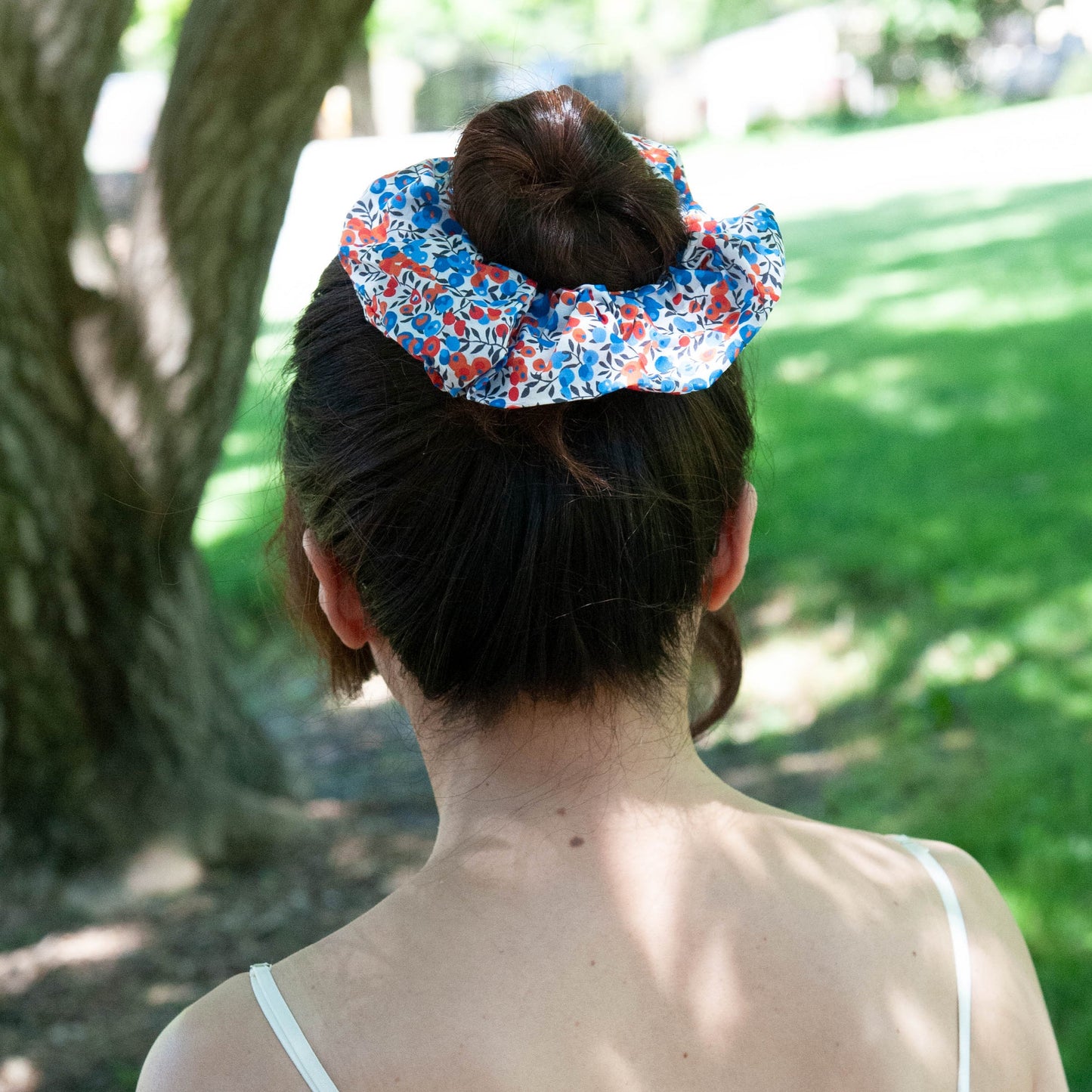 a woman wearing Liberty Fabric Scrunchie in Wiltshire in a bun hairstyle