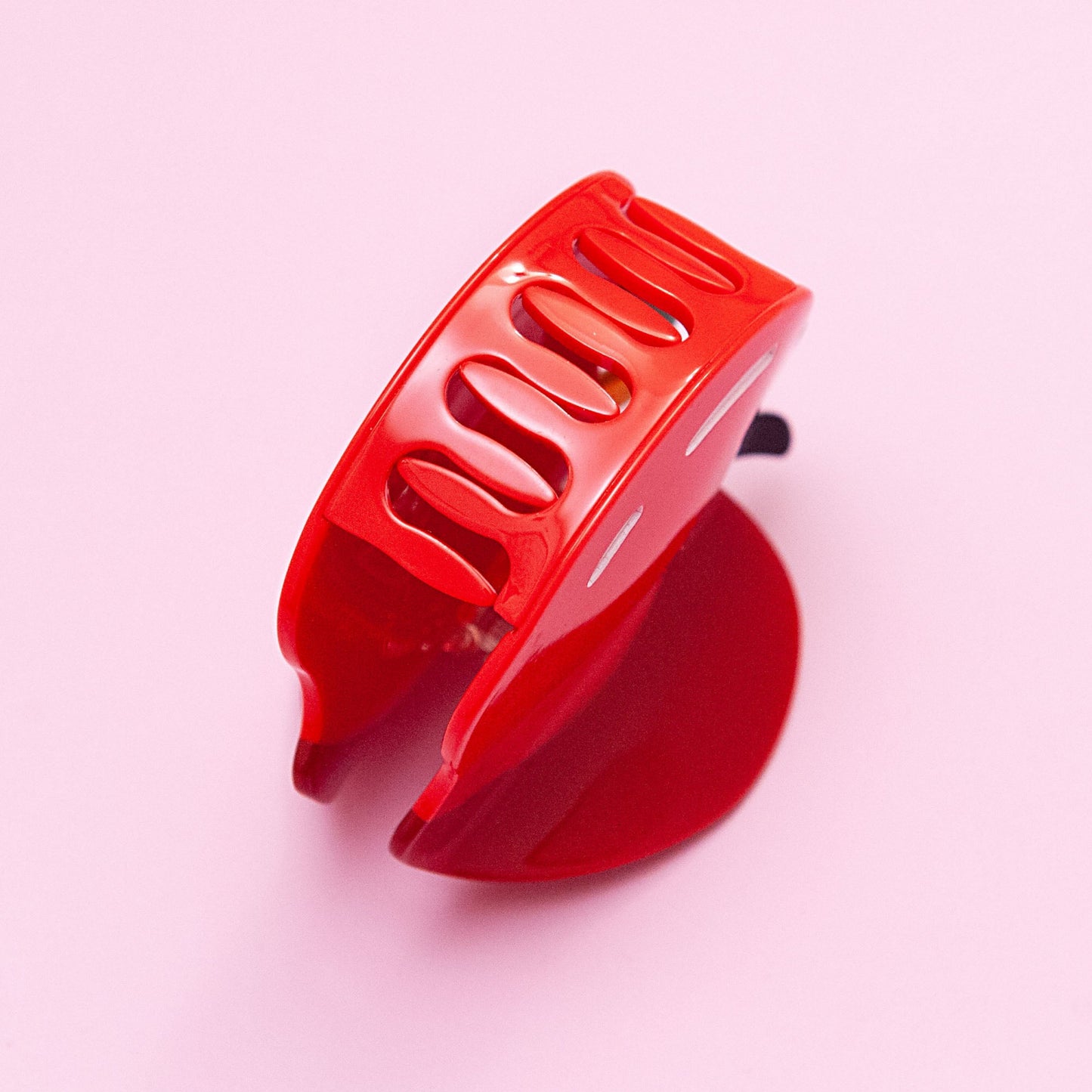 teeth detail of a red apple hair clip