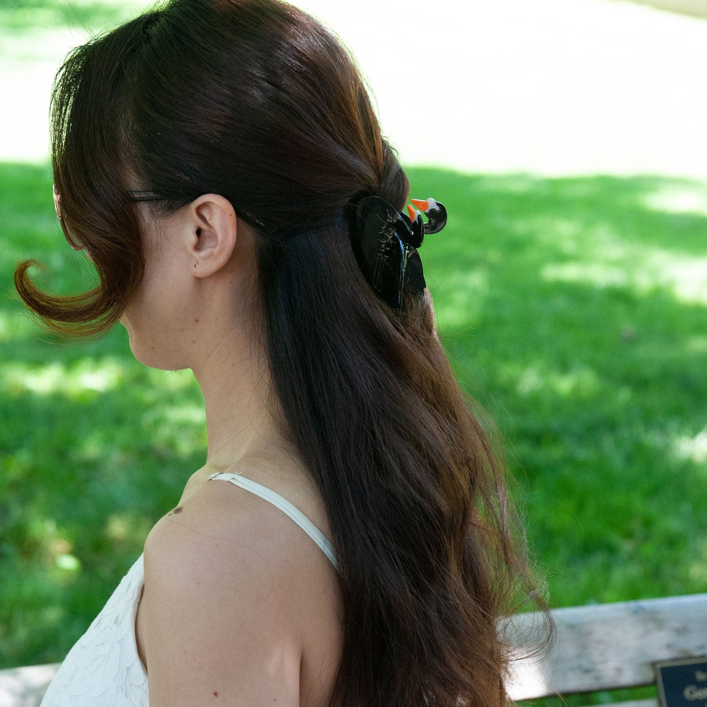 a woman wearing a black swan hair clip