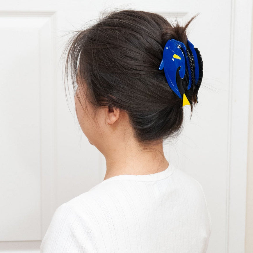 Blue Tang Claw Clip worn in a full-up hairstyle, showing its size and statement design