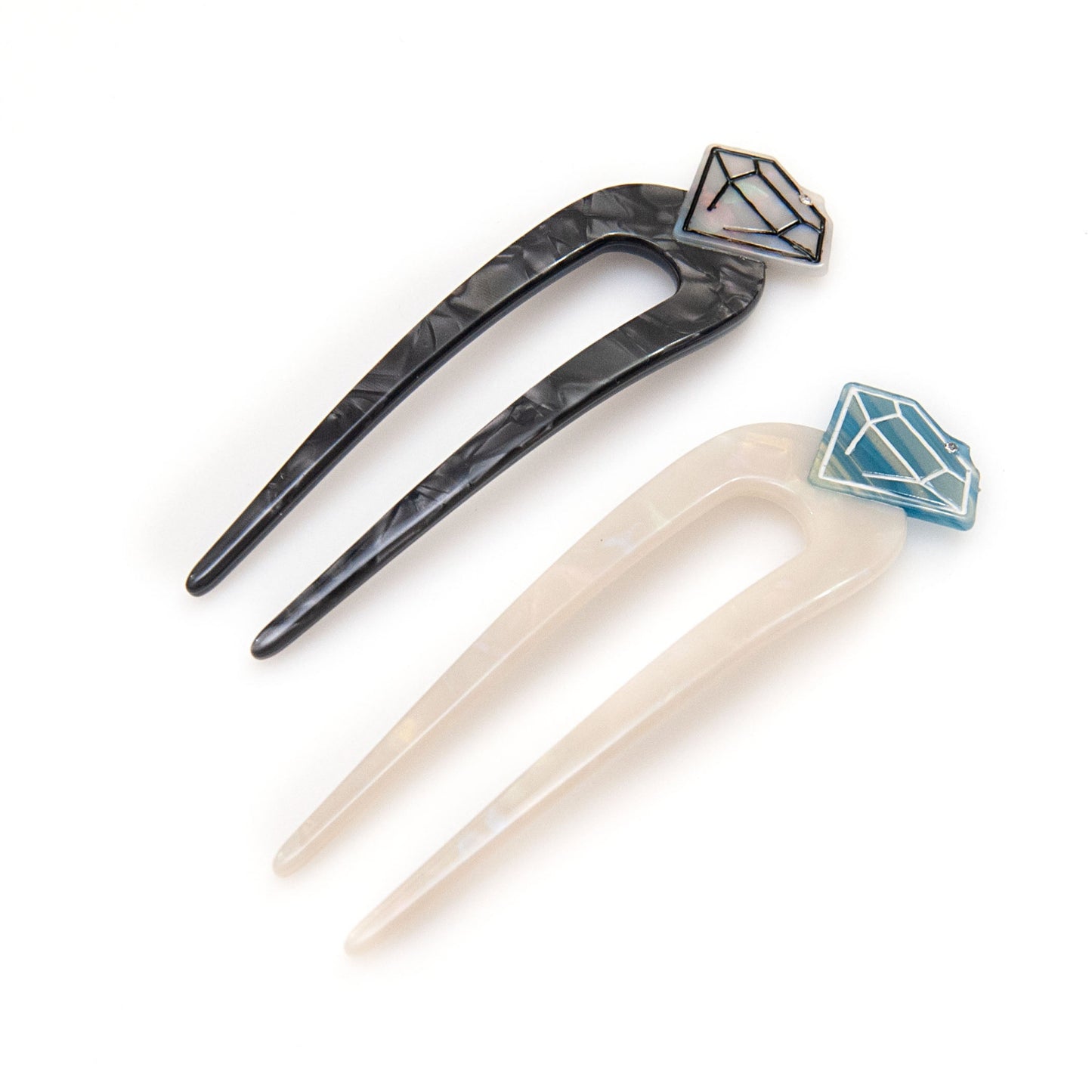 fun hair pin with a diamond design on top in black and white
