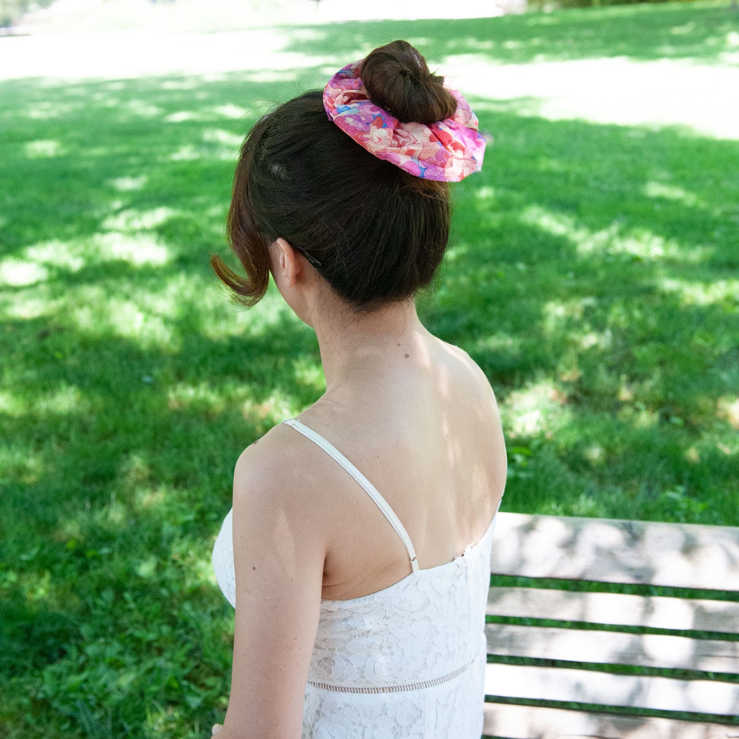 a woman wearing a liberty fabric scrunchie in a bun hairstyle