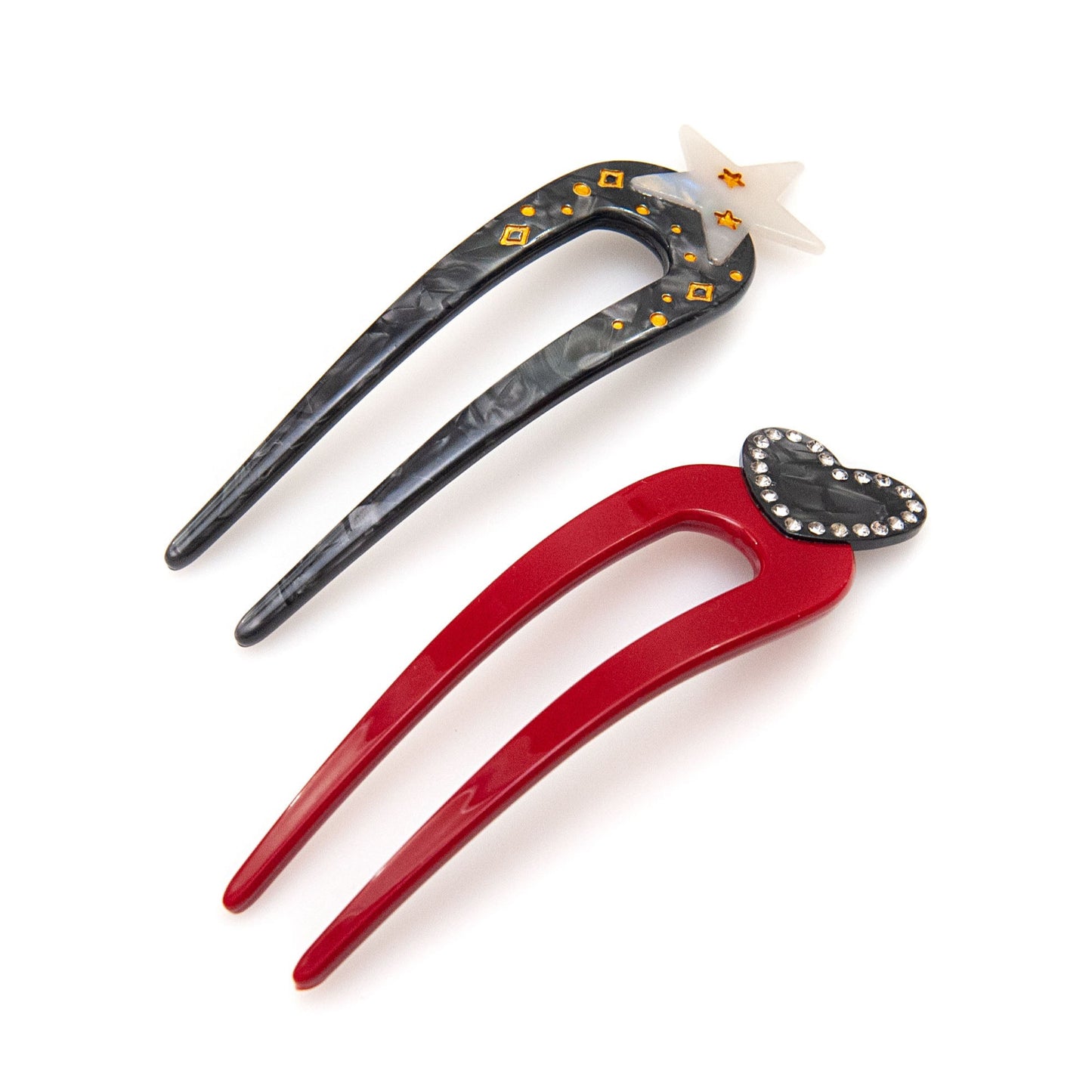a red hair pin and a black hair pin with star design