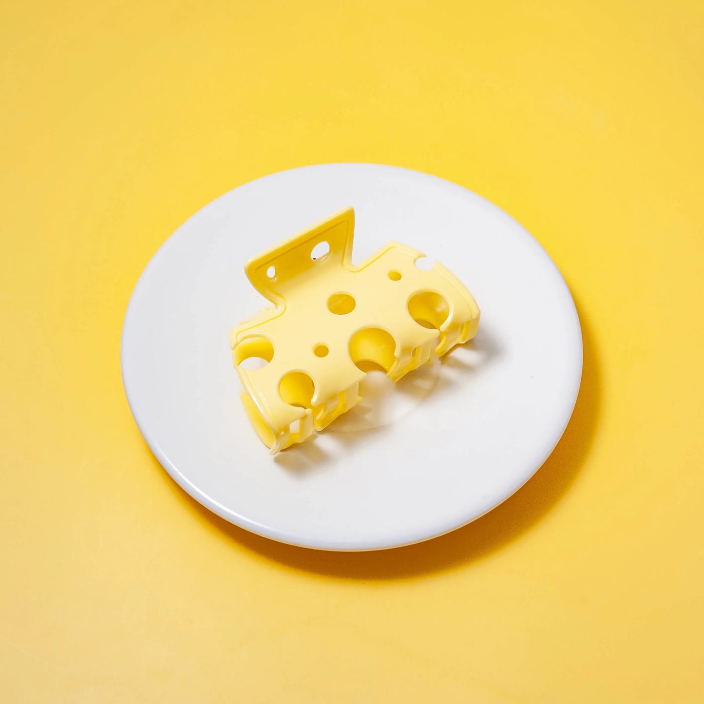 a cheese hair clip on a white plate