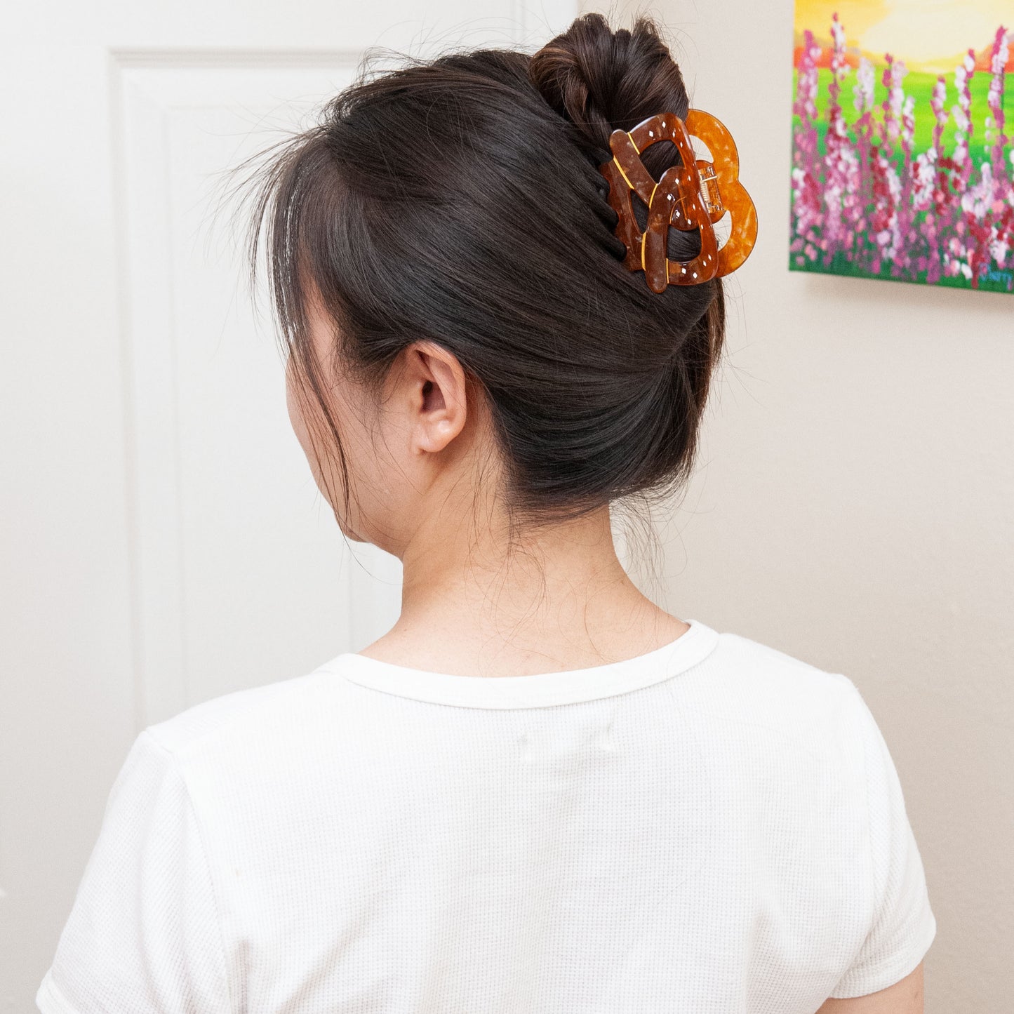a woman wearing a pretzel hair clip