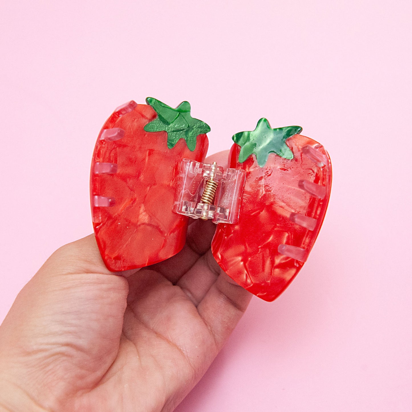 open detail of a red strawberry hair claw clip