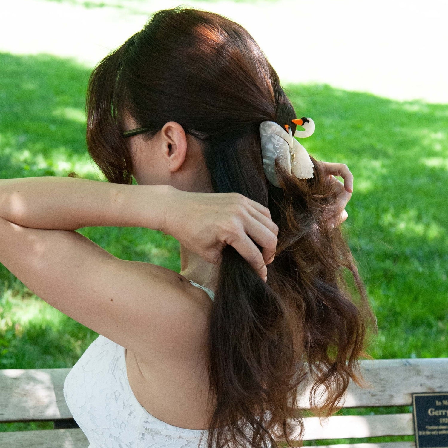a woman wearing our white swan hair claw clip