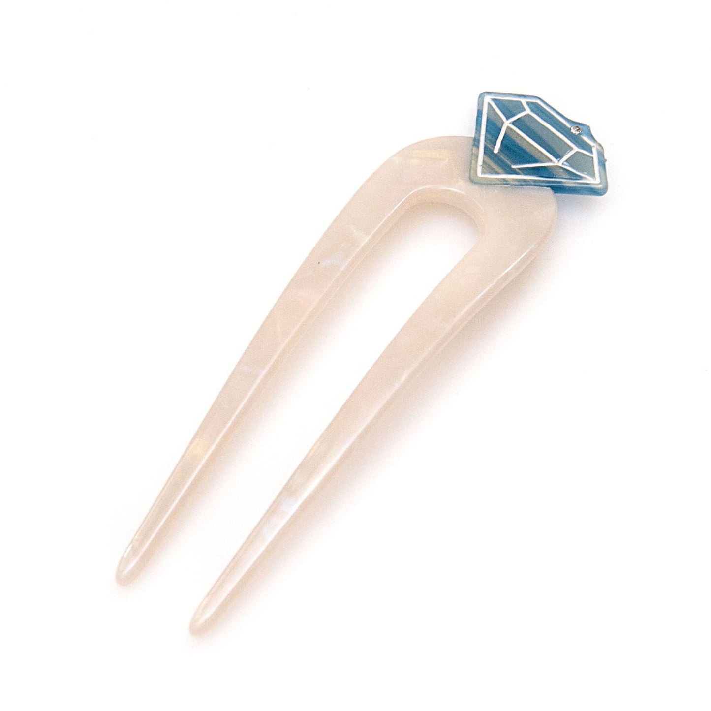 a white hair pin with a blue diamond design on top