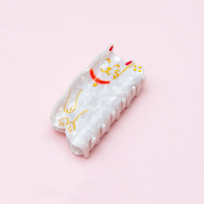 Adorable lucky cat hair claw featuring a playful design inspired by the iconic Maneki-neko, with a raised paw and vibrant colors, perfect for adding a touch of charm and luck to any hairstyle.