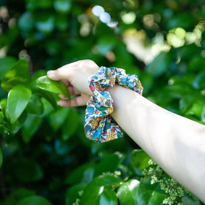 Image of a cotton hair scrunchie featuring a charming mushroom print design. The scrunchie is handmade from soft cotton fabric and adds a playful touch to any hairstyle.