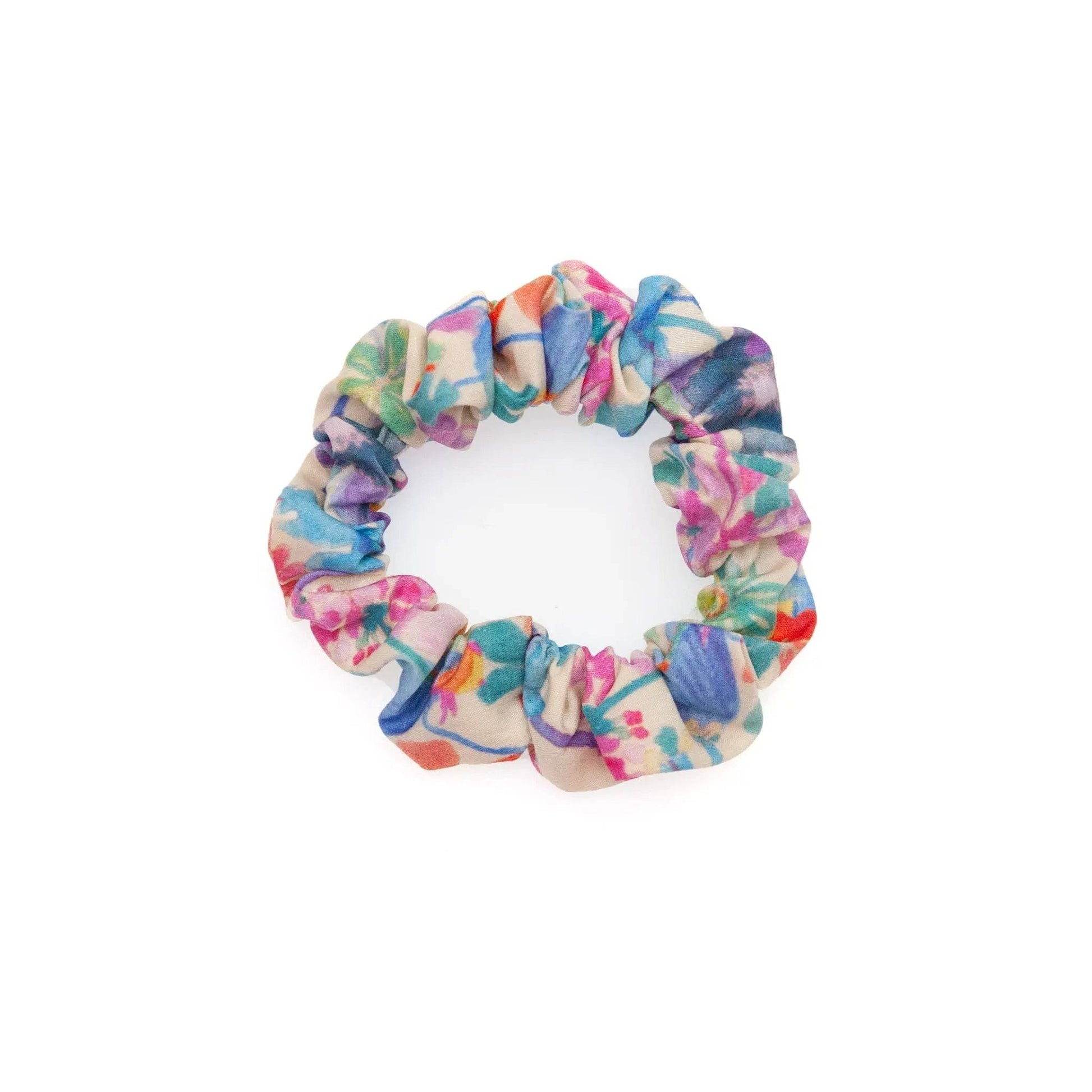 Watercolor fabric scrunchie featuring a vibrant and artistic design, perfect for adding a pop of color to any hairstyle.