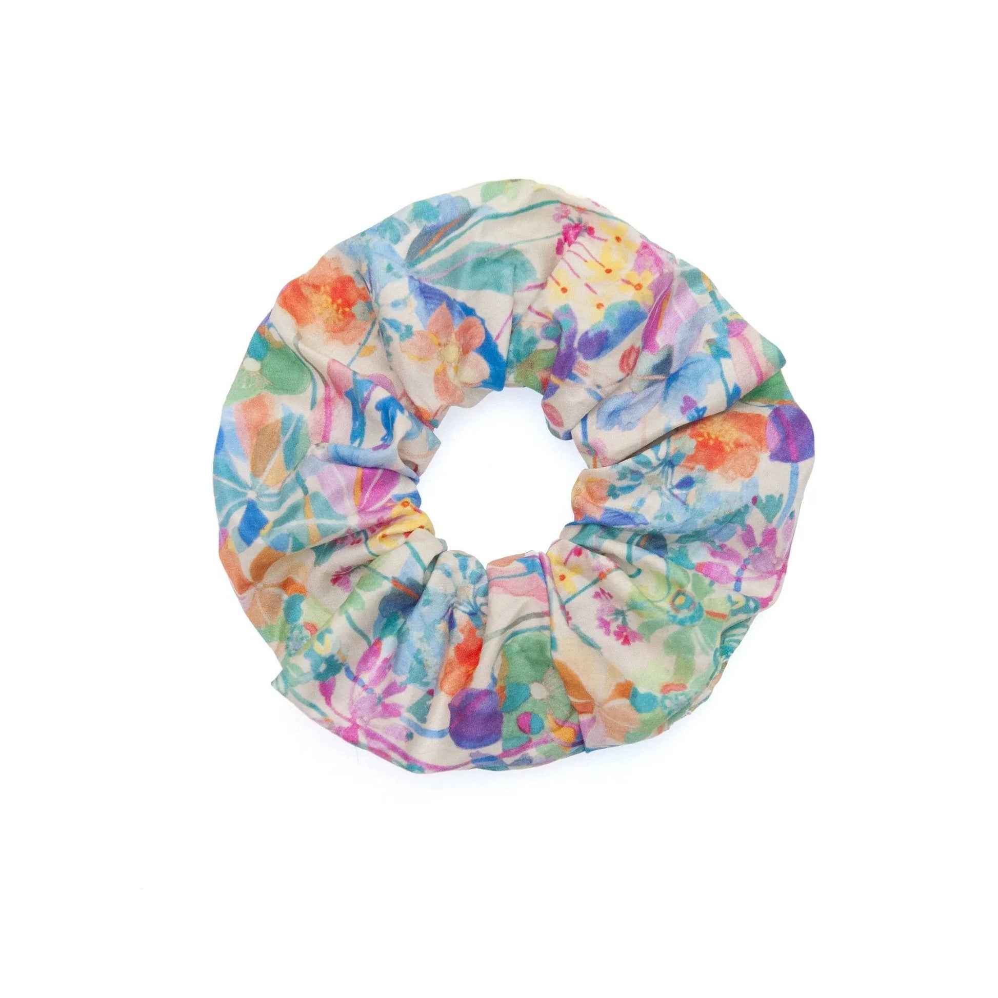 Watercolor fabric scrunchie featuring a vibrant and artistic design, perfect for adding a pop of color to any hairstyle.