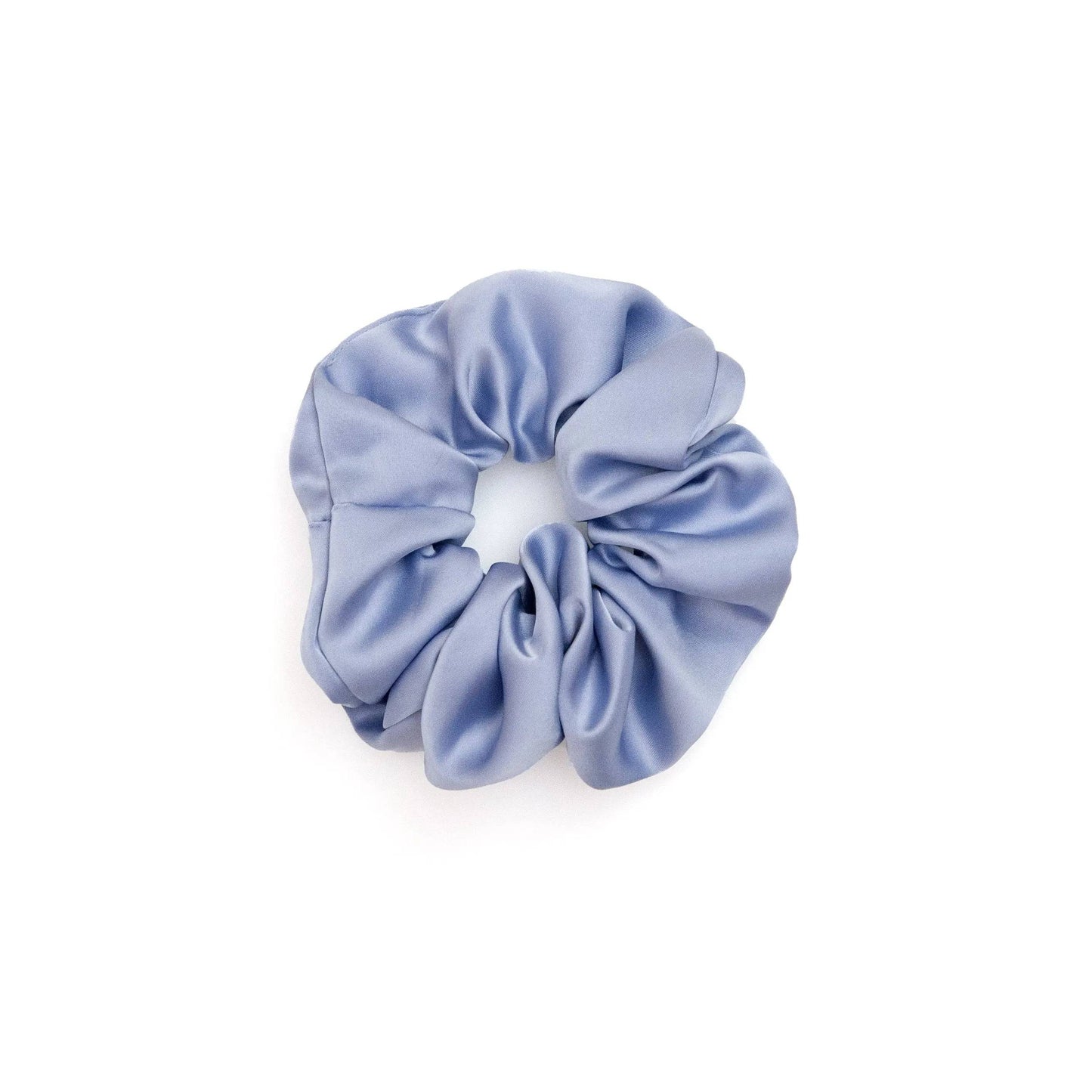 A collection of vibrant satin scrunchies in various colors, displayed neatly on a white surface. The scrunchies are soft and glossy, showcasing their luxurious texture and elegant appeal.