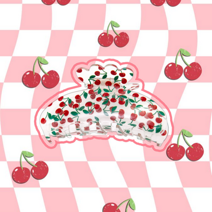 Clear hair claw clip with cherry design on a pink and white checkered background with cherries.