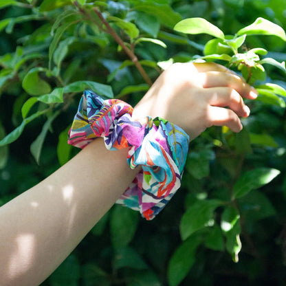 wearing a scrunchie on her wrist that is made from liberty fabric in jungle trip pattern