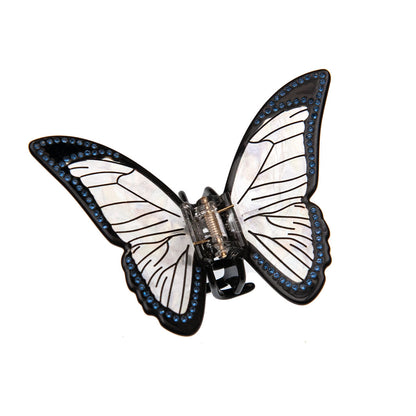 Black butterfly claw clip with iridescent wings on a white background.
