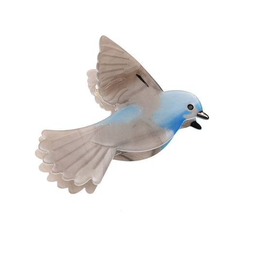 flying blue bird hair clip on a white background