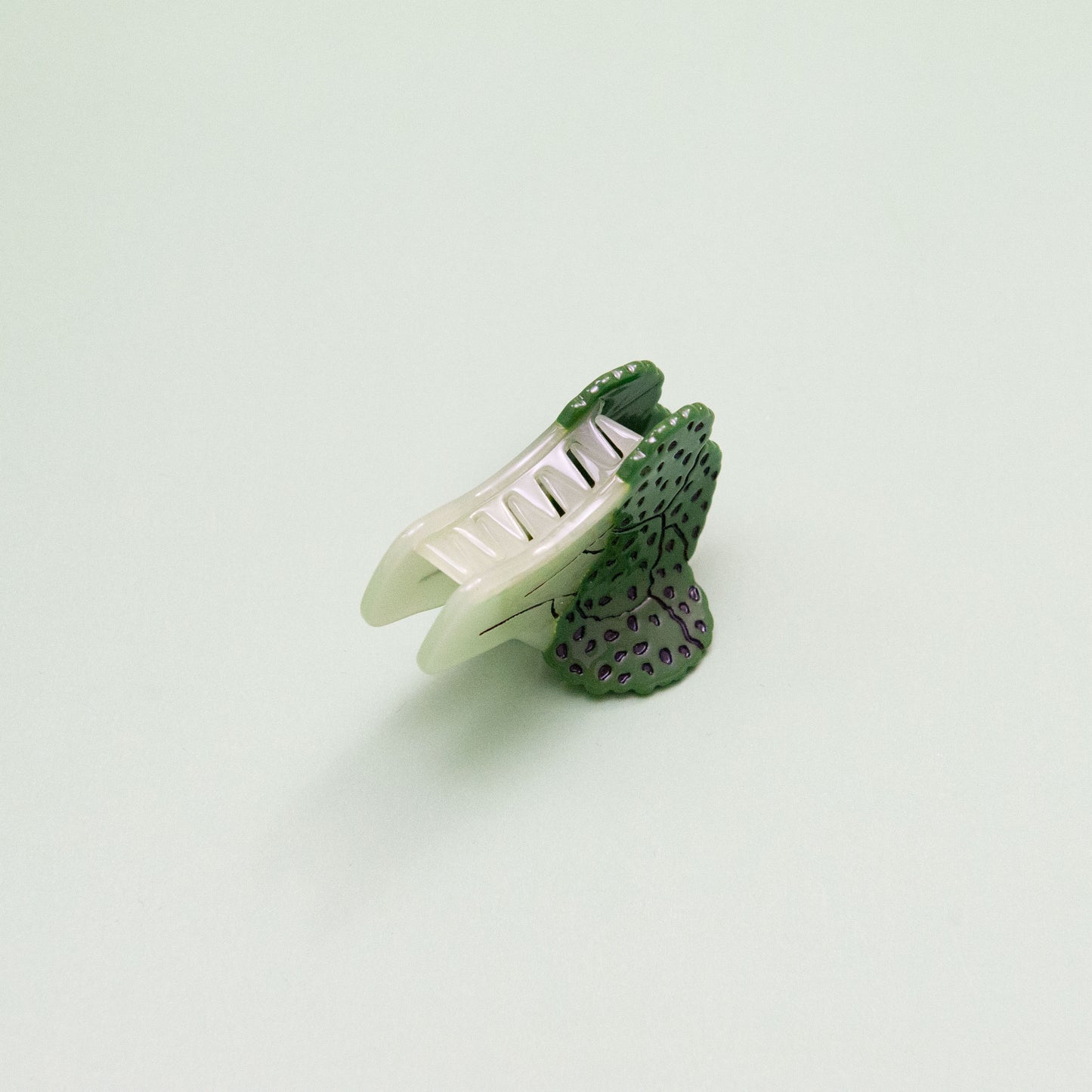 Cute and whimsical broccoli hair claw made from iridescent cellulose acetate with detailed texture.