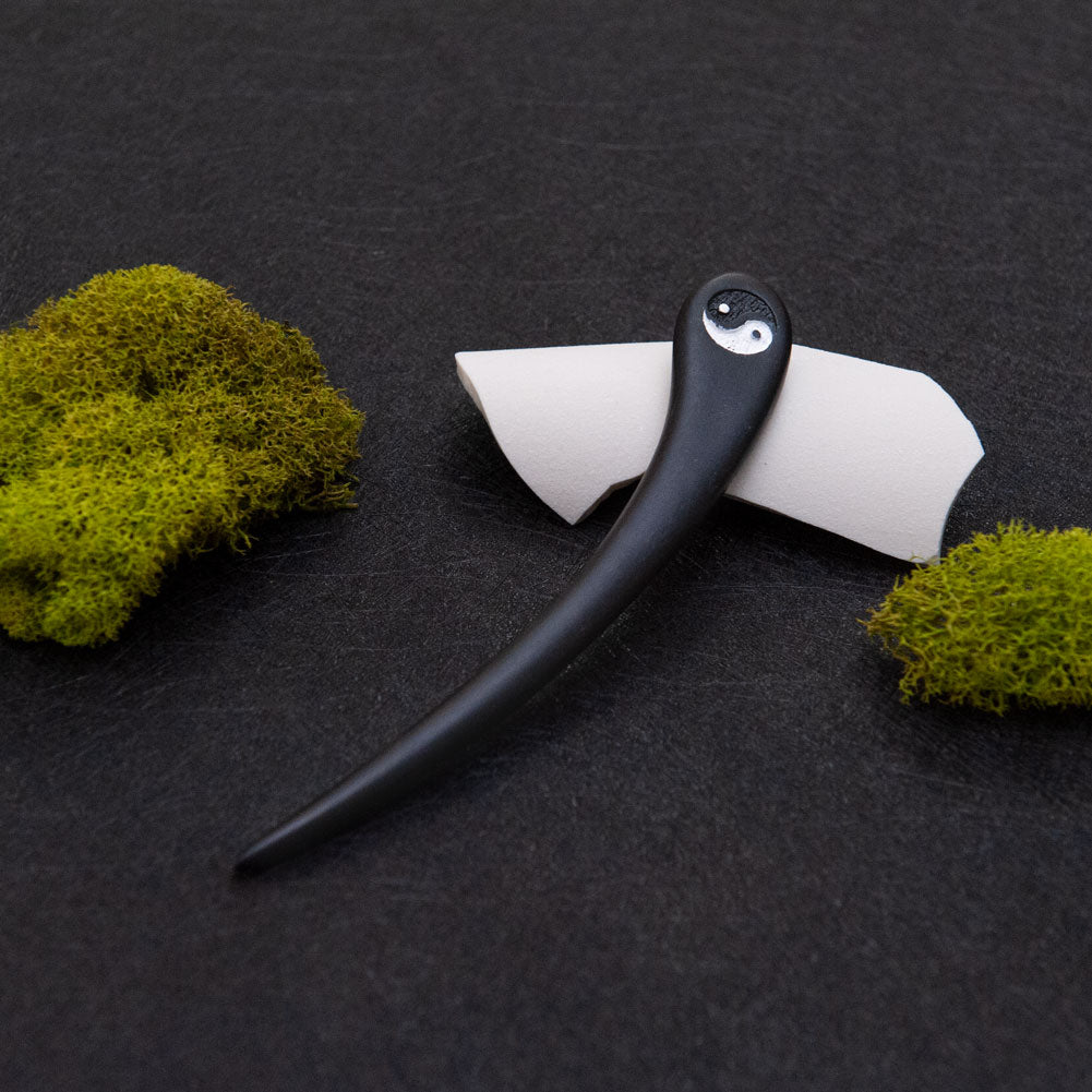 Black hair stick with a Yin Yang design