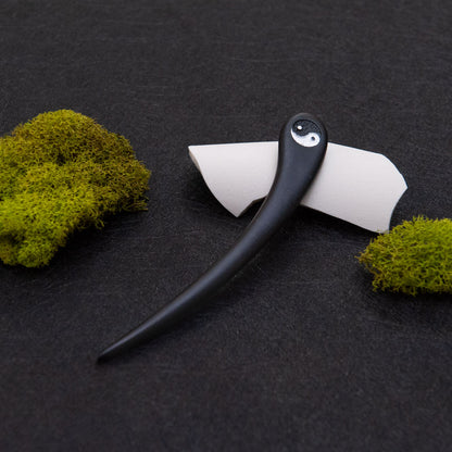 Black hair stick with a Yin Yang design
