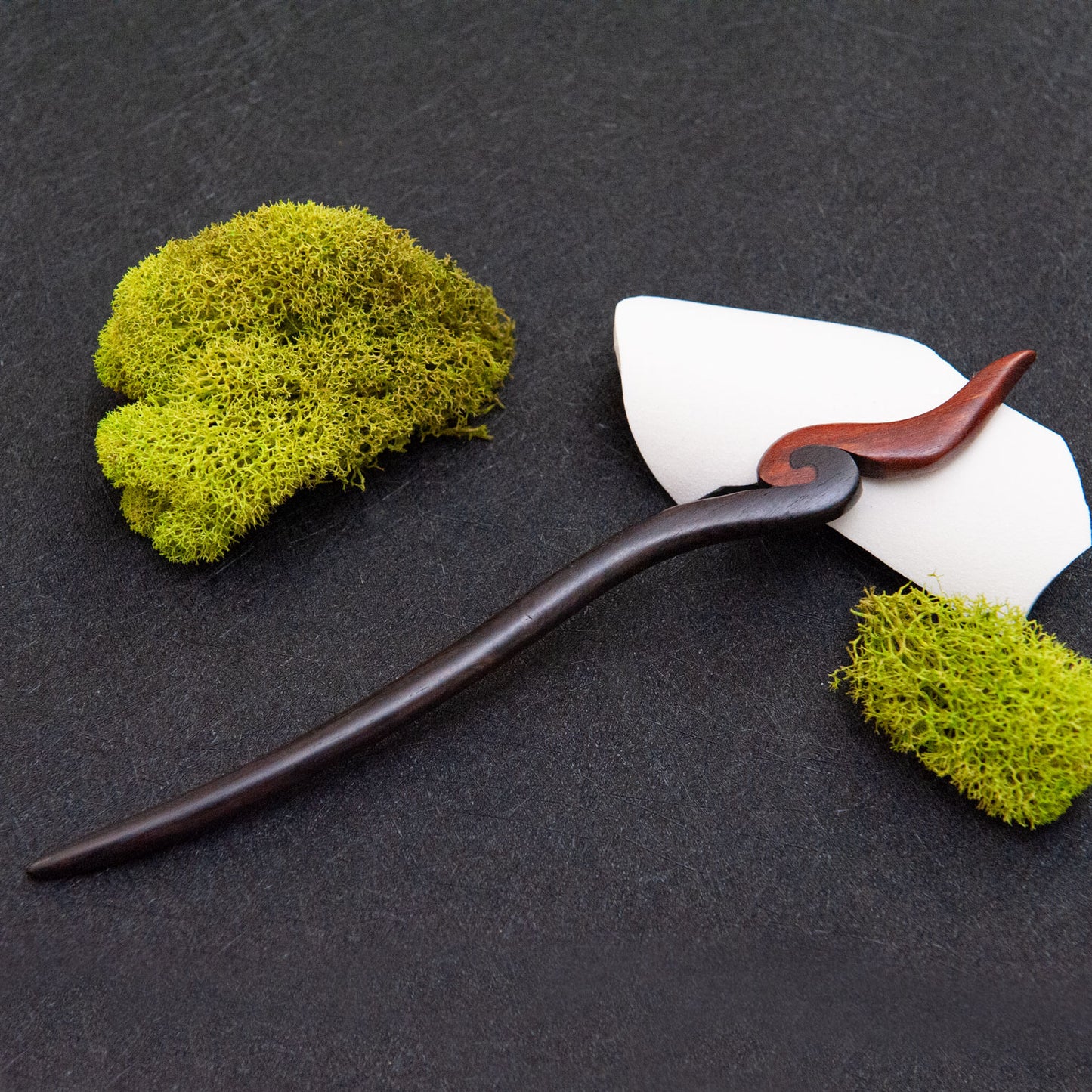 Ebony hair stick with a smooth black body and a small red fire-inspired tip at the end.