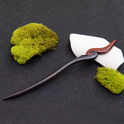 Ebony hair stick with a smooth black body and a small red fire-inspired tip at the end.