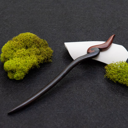 Ebony hair stick with a smooth black body and a small red fire-inspired tip at the end.