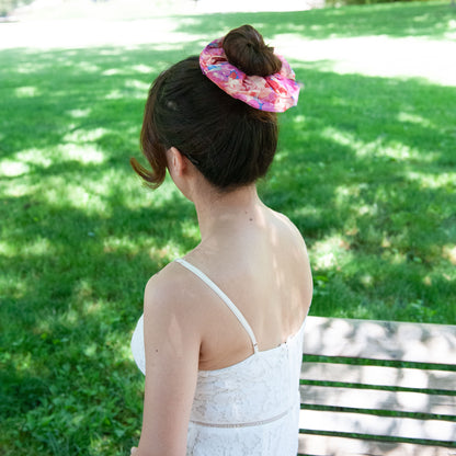 a woman wearing a liberty fabric scrunchie in a bun hairstyle