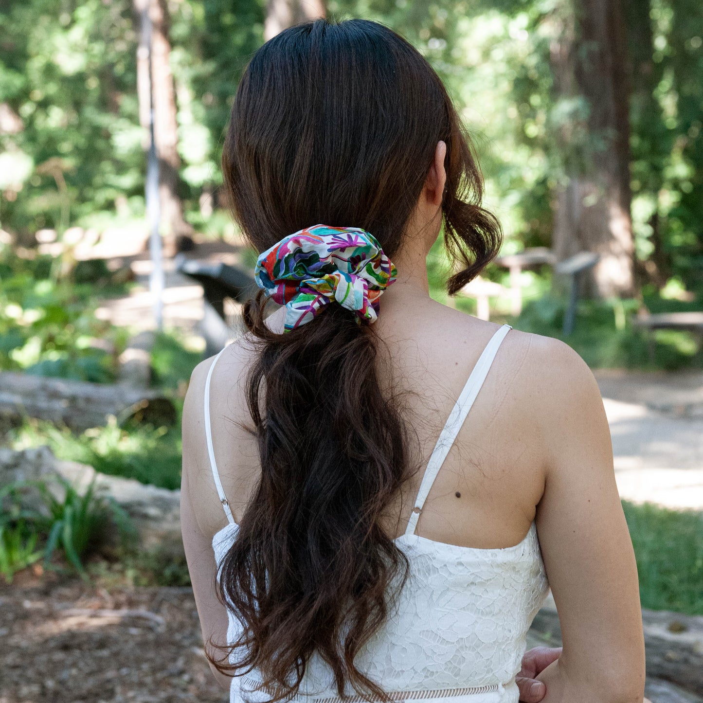 a woman wearing a large liberty fabric scrunchie in a ponytail