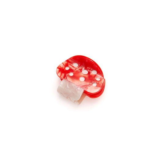 Whimsical mushroom hair claw for a unique and charming hairstyle accent.