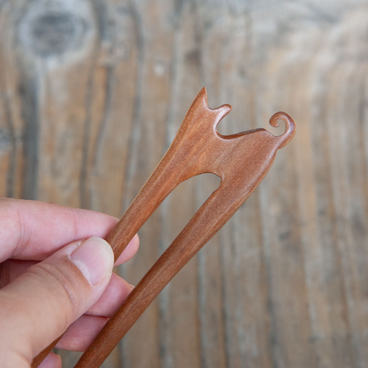 wooden hair stick with a cat design