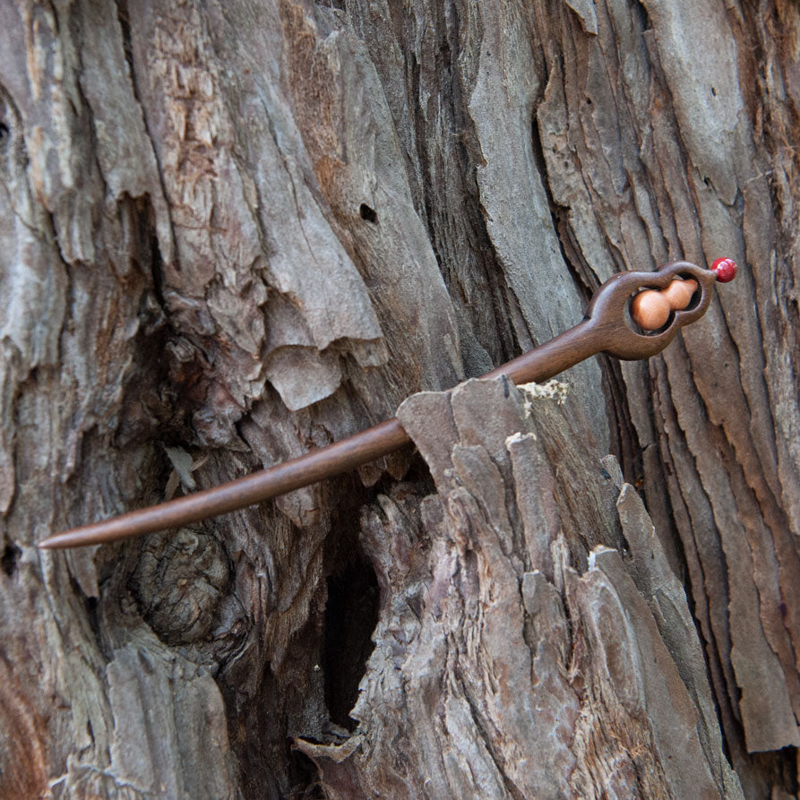 wooden hair stick with gourd design on a natural background